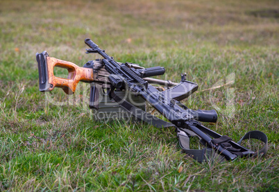two machine guns lying in the grass