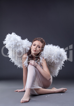 Studio shot of sad woman in guardian angel costume