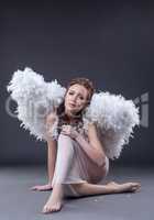 Studio shot of sad woman in guardian angel costume