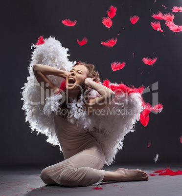 Beautiful angel screams in pain. Photo concept