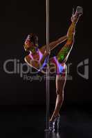 Pole dance. Sexy dancer with fluorescent bodyart