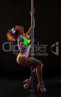 Pole dance under neon light. Sexy woman posing
