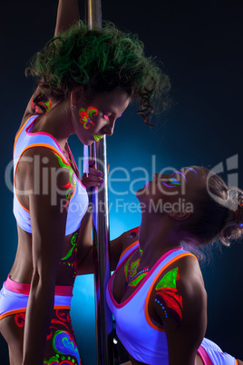 Artistic dancers with bright glowing bodyart