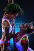 Artistic dancers with bright glowing bodyart