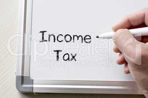Income tax written on whiteboard