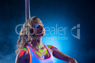 Beautiful pole dancer posing with her eyes closed