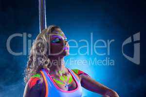 Beautiful pole dancer posing with her eyes closed