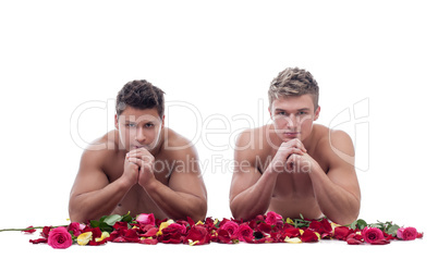 Two handsome guys posing naked with rose petals