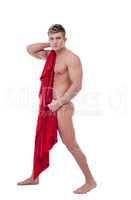 Handsome young guy covers his nakedness with cloth