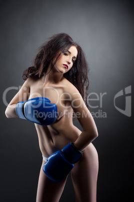 Gorgeous nude brunette posing in boxing gloves