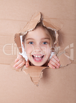 kid portrait in torn paper hole