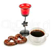cup with coffee, biscuits and a candlestick isolated on a white