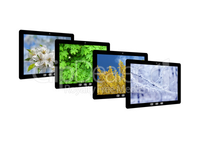 four tablet computers with images of seasons