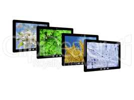 four tablet computers with images of seasons
