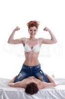 Girl shows biceps while sitting astride on guy