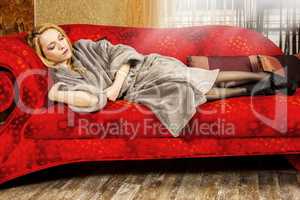 Woman in bathrobe on the sofa