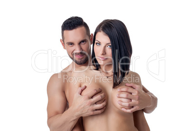 Grinning man touches breasts of his girlfriend