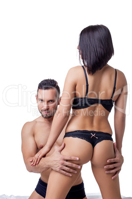 Sexy guy posing at camera while hugging hot woman