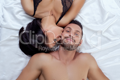 Top view of man smiling while hot woman kissed him
