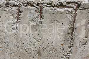 old concrete wall with reinforcement bars
