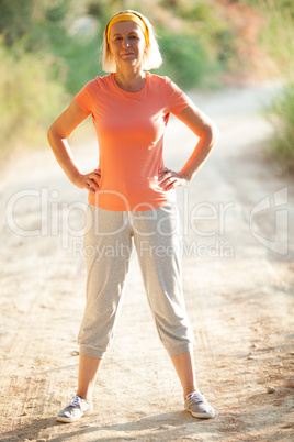 Mature Woman Standing with Hands on Hips on Road