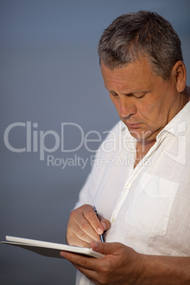 Man Using Pen on Handheld Tablet Computer