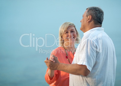 Middle-aged couple dancing on a romantic song