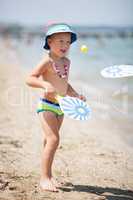 Young Boy Playing Paddle Ball on Sunny Beach