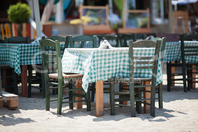 Empty Tables and Chairs on Sunny Restaurant Patio