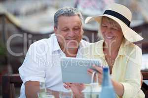 Smiling middle-aged couple using a tablet