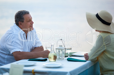 Middle-aged couple sitting waiting for a meal