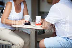 Couple Enjoying Coffee and Desserts on Cafe Patio