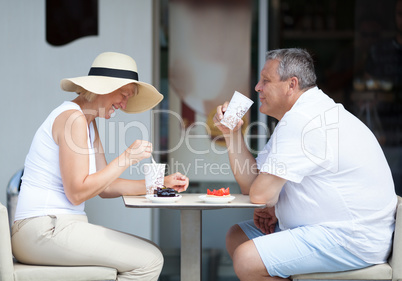 Couple Enjoying Coffee and Desserts on Cafe Patio