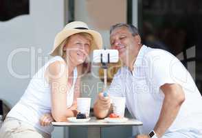 Adult couple taking selfie with cell phone