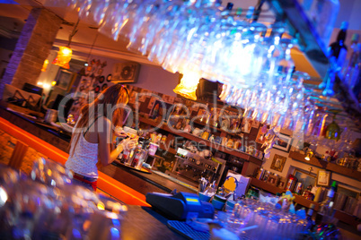 Young woman enjoying a drink in a cocktail bar