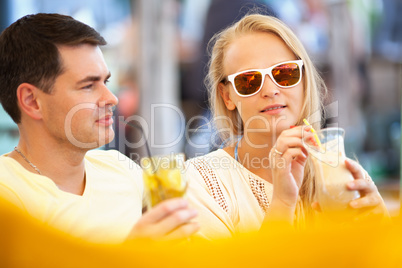 Young couple relaxing with refreshing drinks