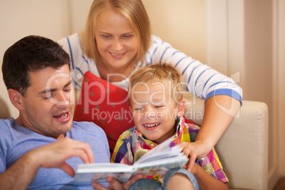 Family reading book together at home