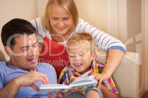 Family reading book together at home