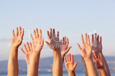 Unrecognizable people pulling hands in the air