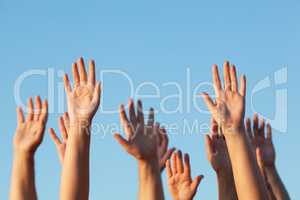 Group of people raising their hands in the air