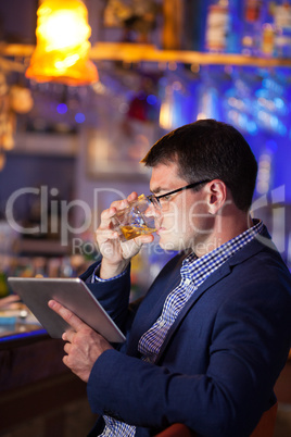 Businessman enjoying a drink at a club