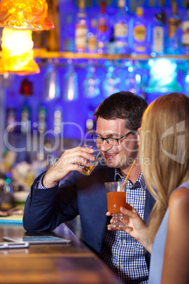 Handsome man enjoying drinks with a woman