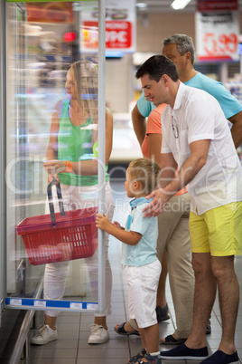 Family choosing food in supermarket