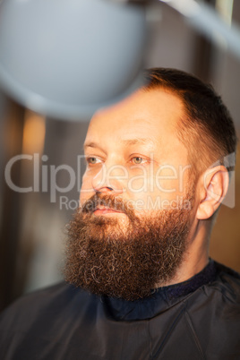 Attractive bearded man in a barber shop