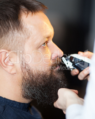 Man having his mustache trimmed at a barber