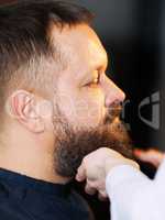 Side view of adult man at barbershop