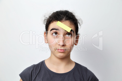 Little girl with memo posts on her forehead,