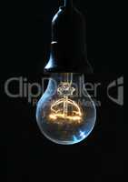 Old light bulb glowing in dark