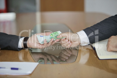 Corruption. Businessman in a suit takes a bribe