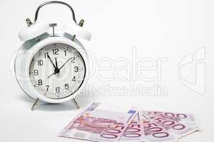 Old Clock and five hundred Euros, European bank withdraws five hundred banknotes.